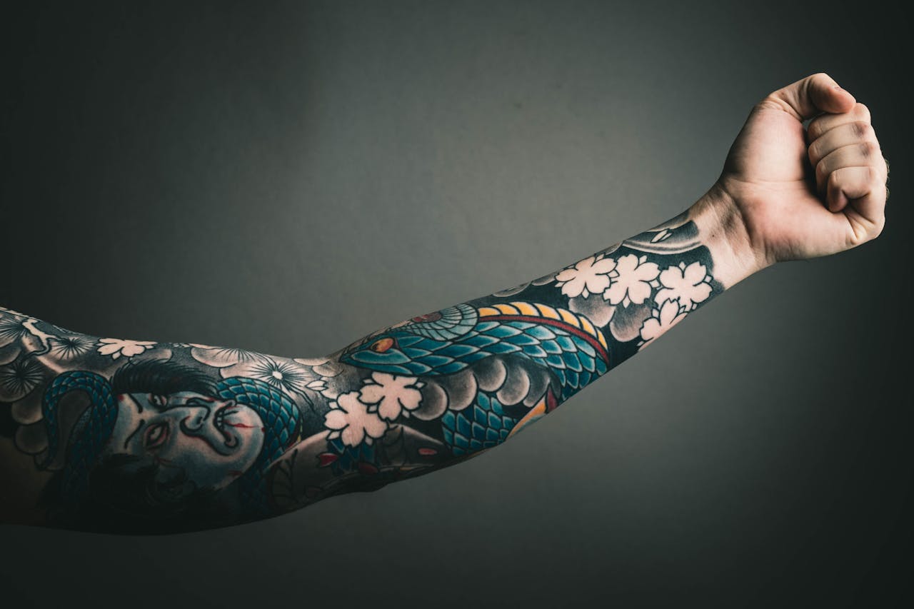 Colourful arm sleeve tattoo